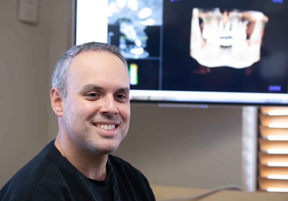 Dr. Carlos during a dental implant consultation