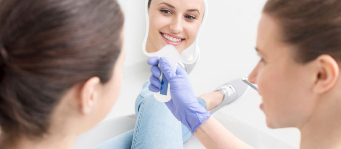 a dental patient smiling after recieving new permanent dental implants